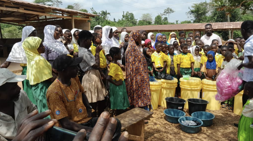 Distributing utensils, cups, and supplies to school children in need