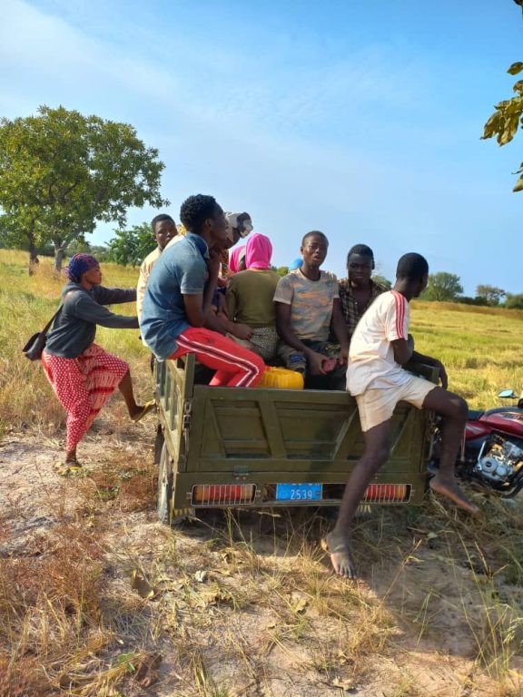 Community members heading home after a day in the fields