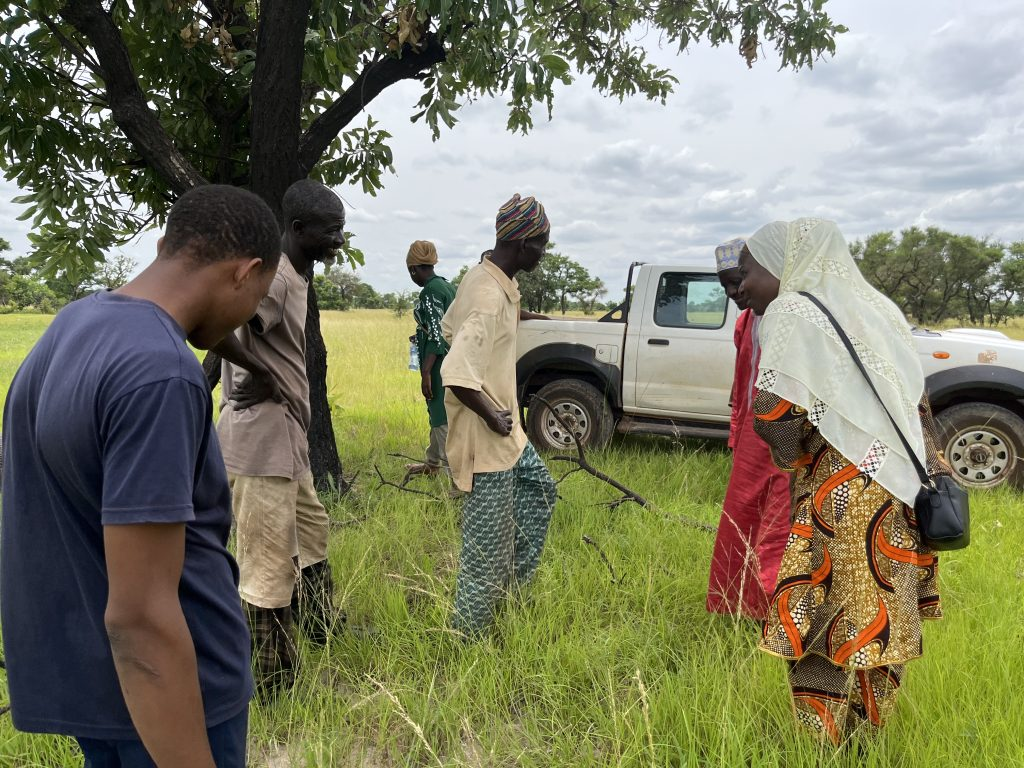 Our founder, Zubeeda Muhammad, viewing farmlands with local farmers